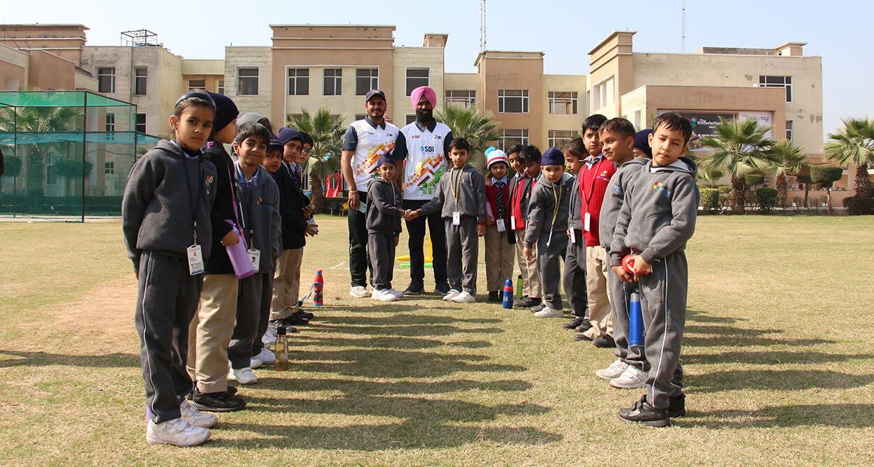 Students at cricket practice on the school lawns