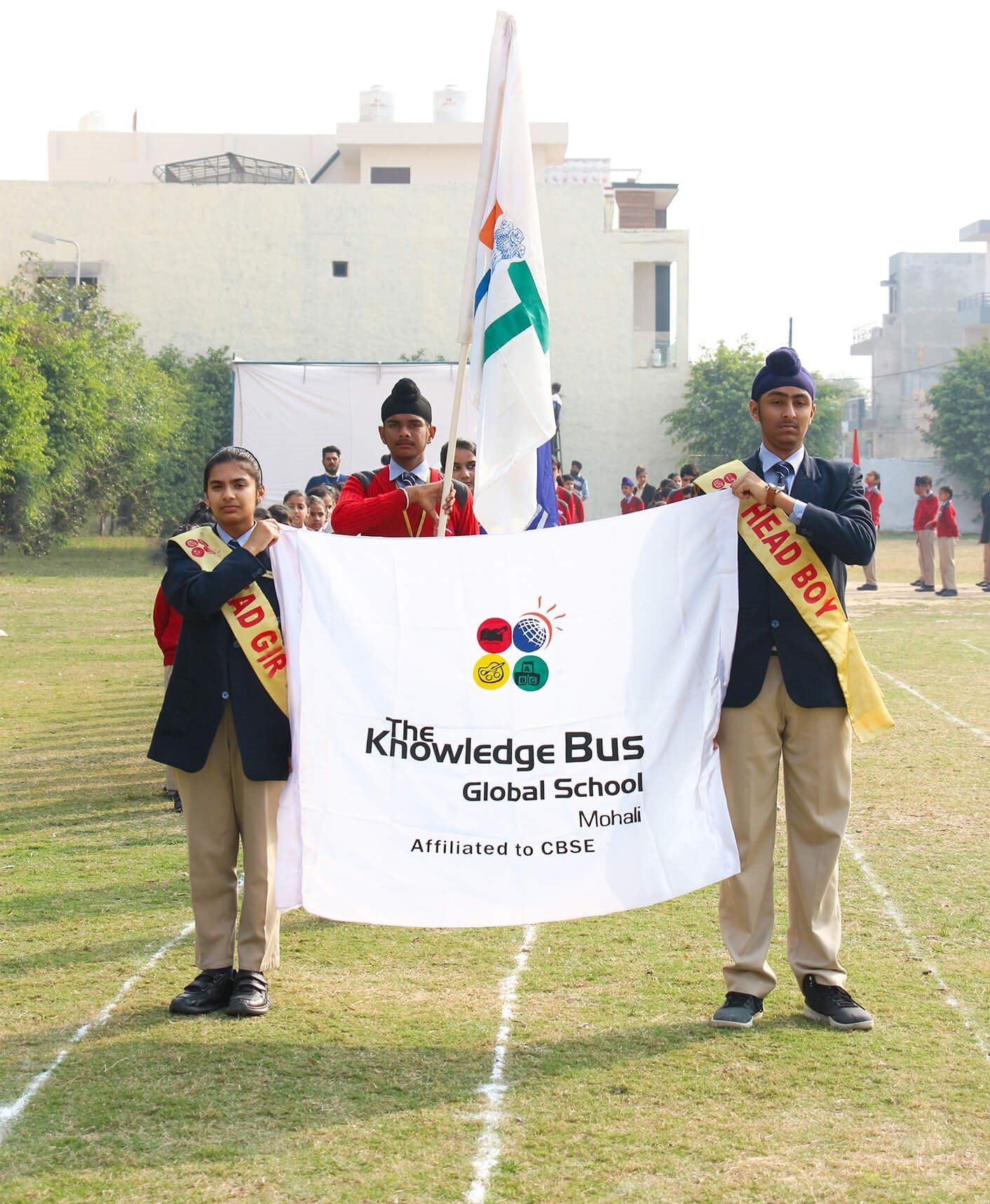 Students carrying the school flag at sports day